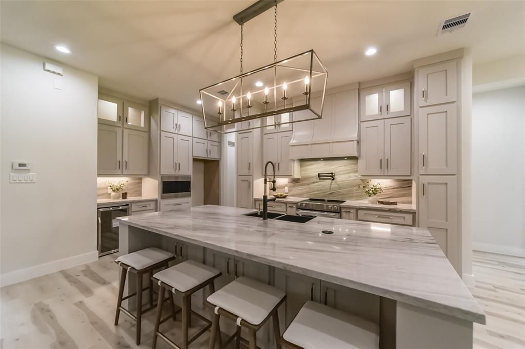 A kitchen with a large island and stools
