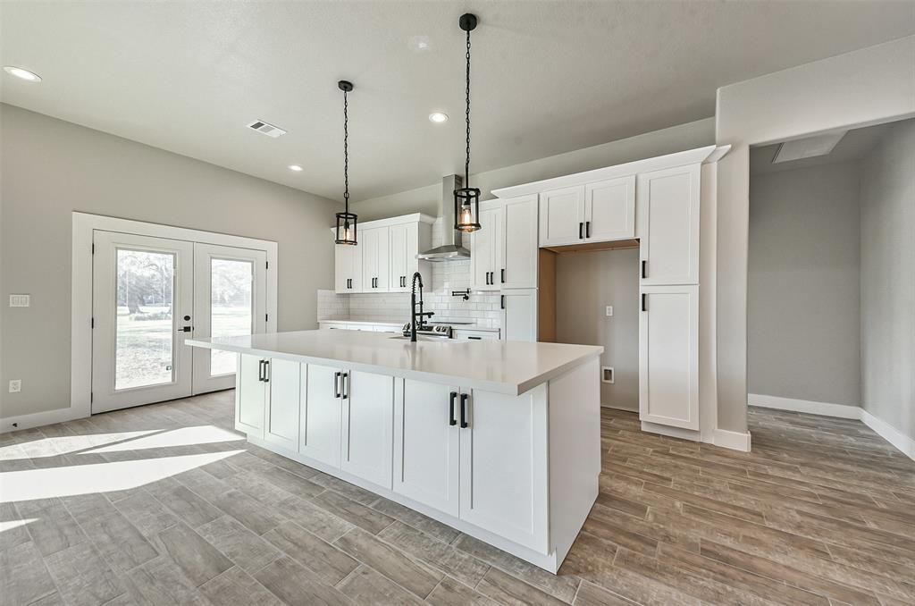 There is a large island in the middle of the kitchen.