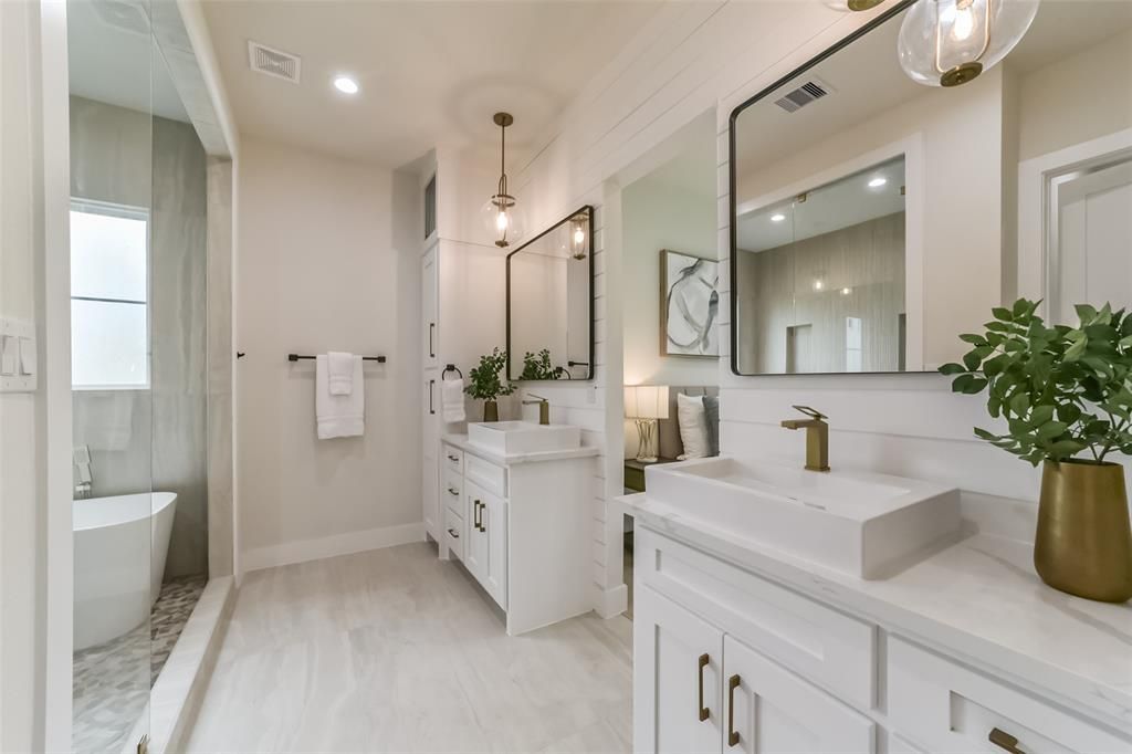 A bathroom with two sinks and two mirrors