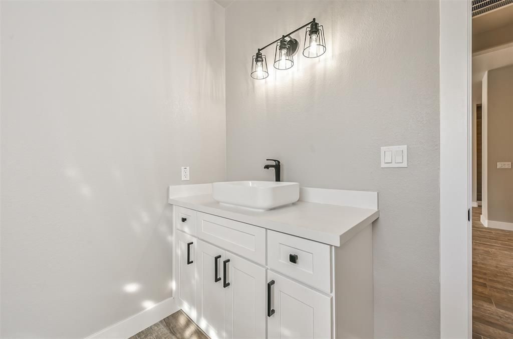 A bathroom with a sink and cabinets in it.