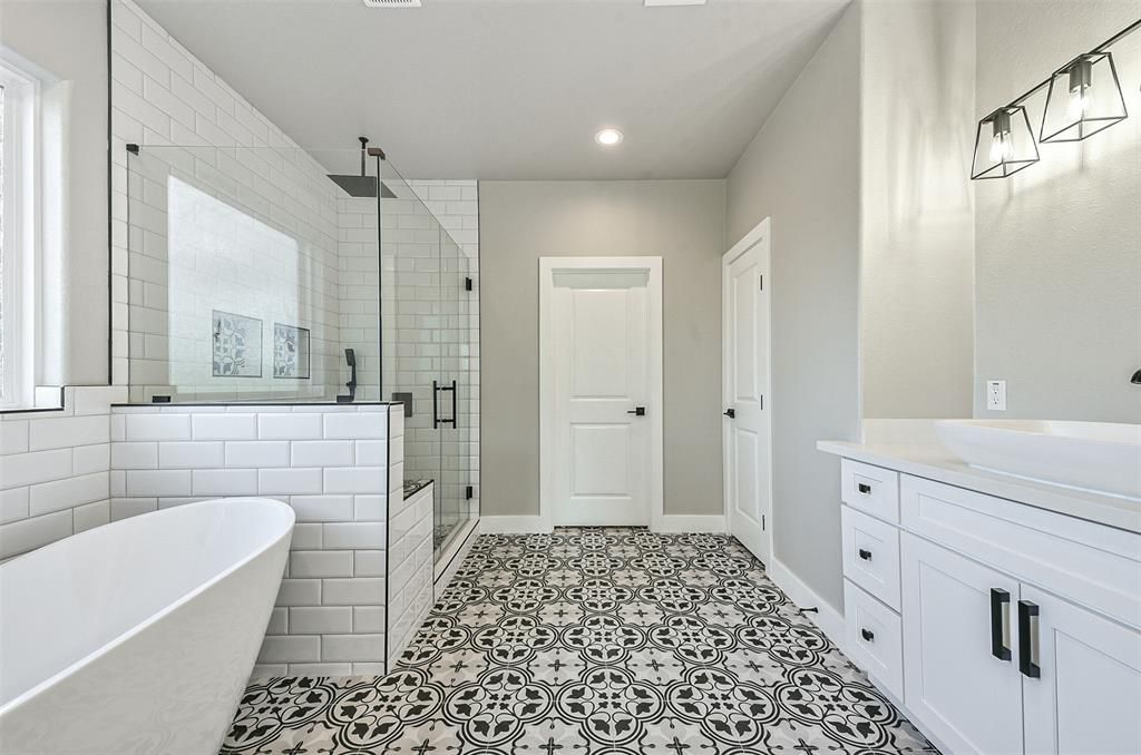 A bathroom with a bathtub and a walk in shower