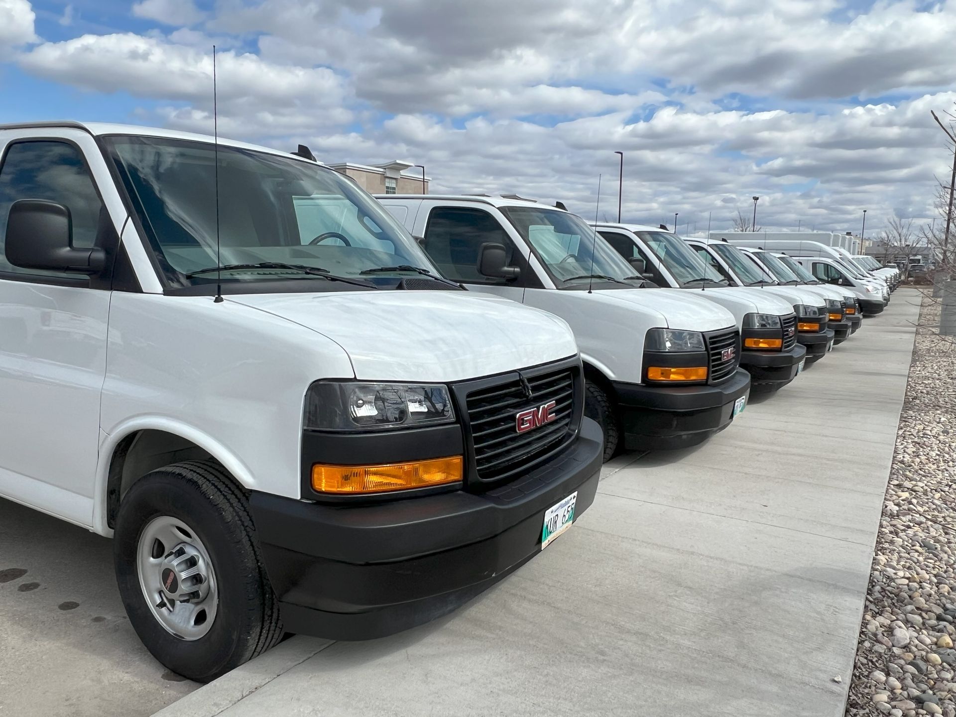 Row of GMC and Chevrolet Cargo Vans