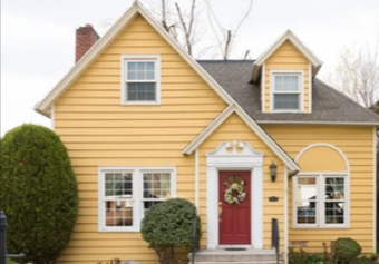 a yellow house with a red front door