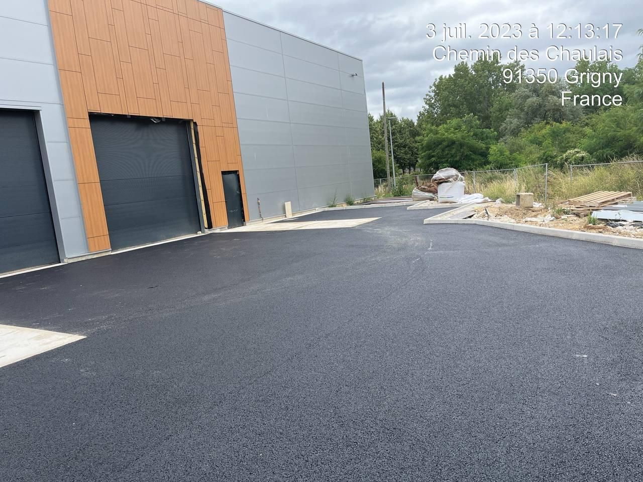 Un immeuble avec beaucoup de portes de garage est en construction.