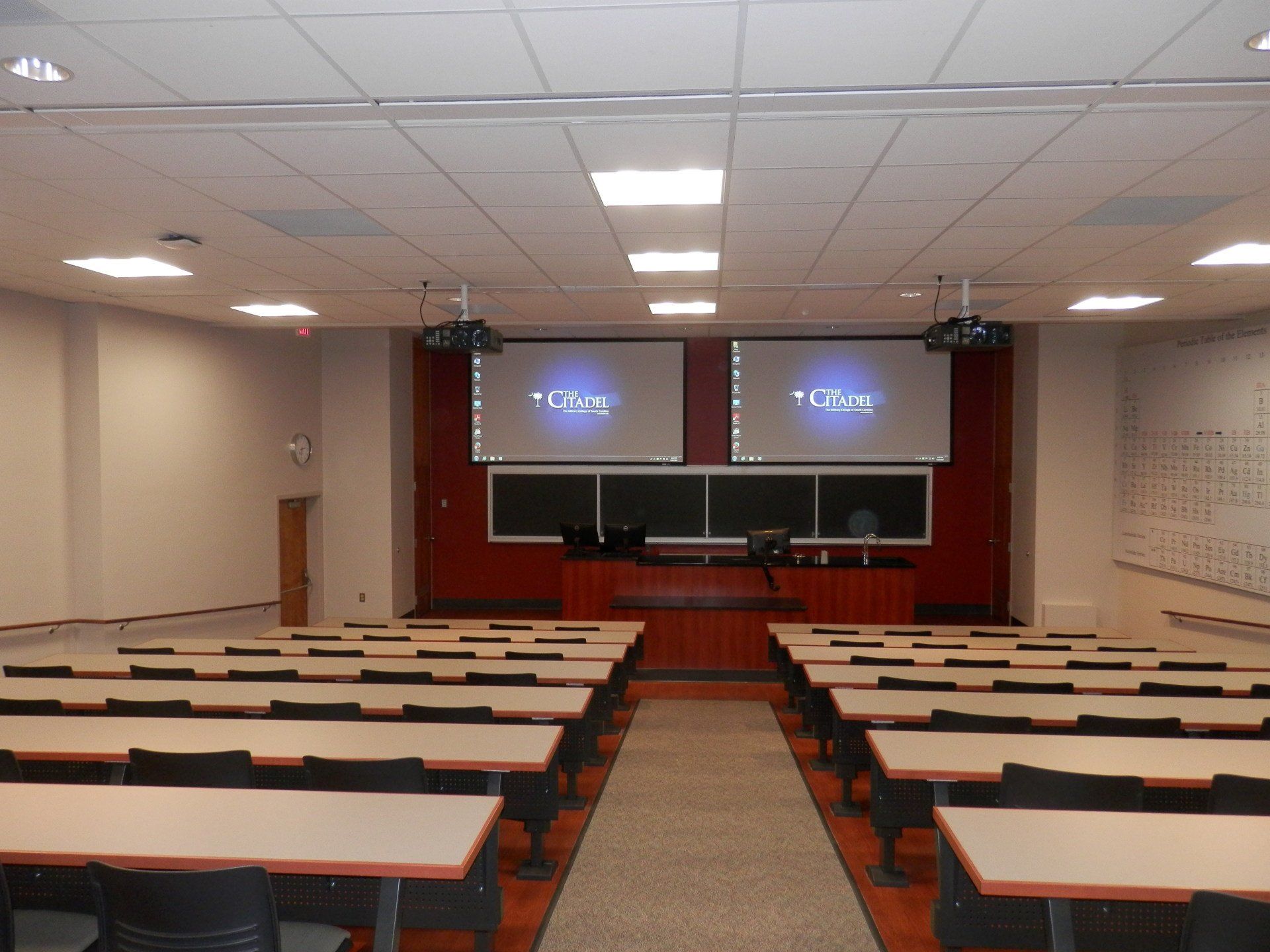 a large lecture hall with rows of tables and chairs