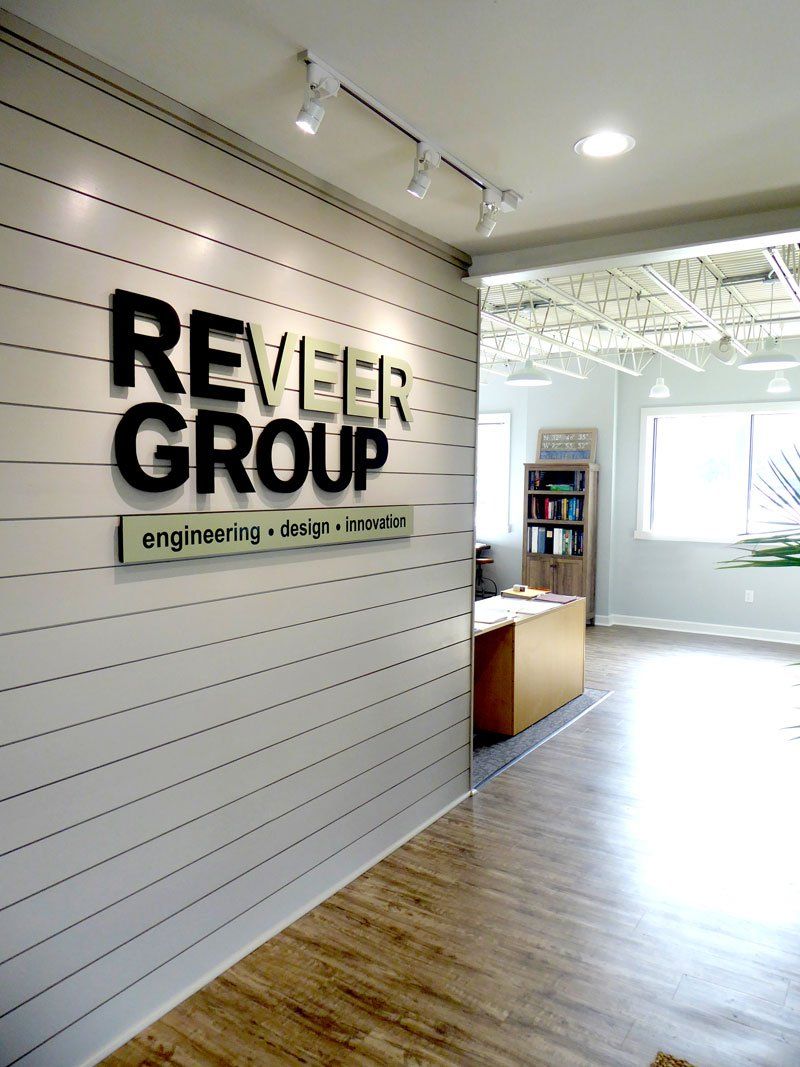 a room with a sign on the wall that says reveler group