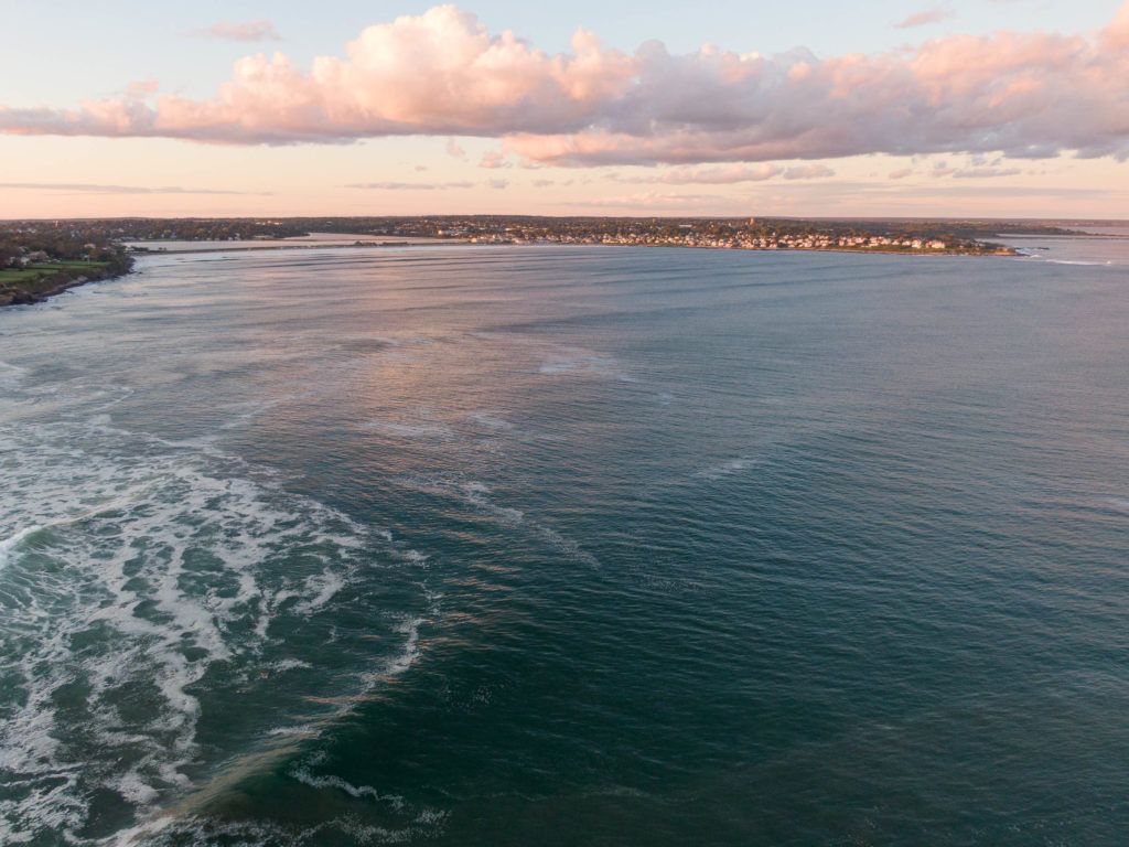 an aerial view of a large body of water at sunset .