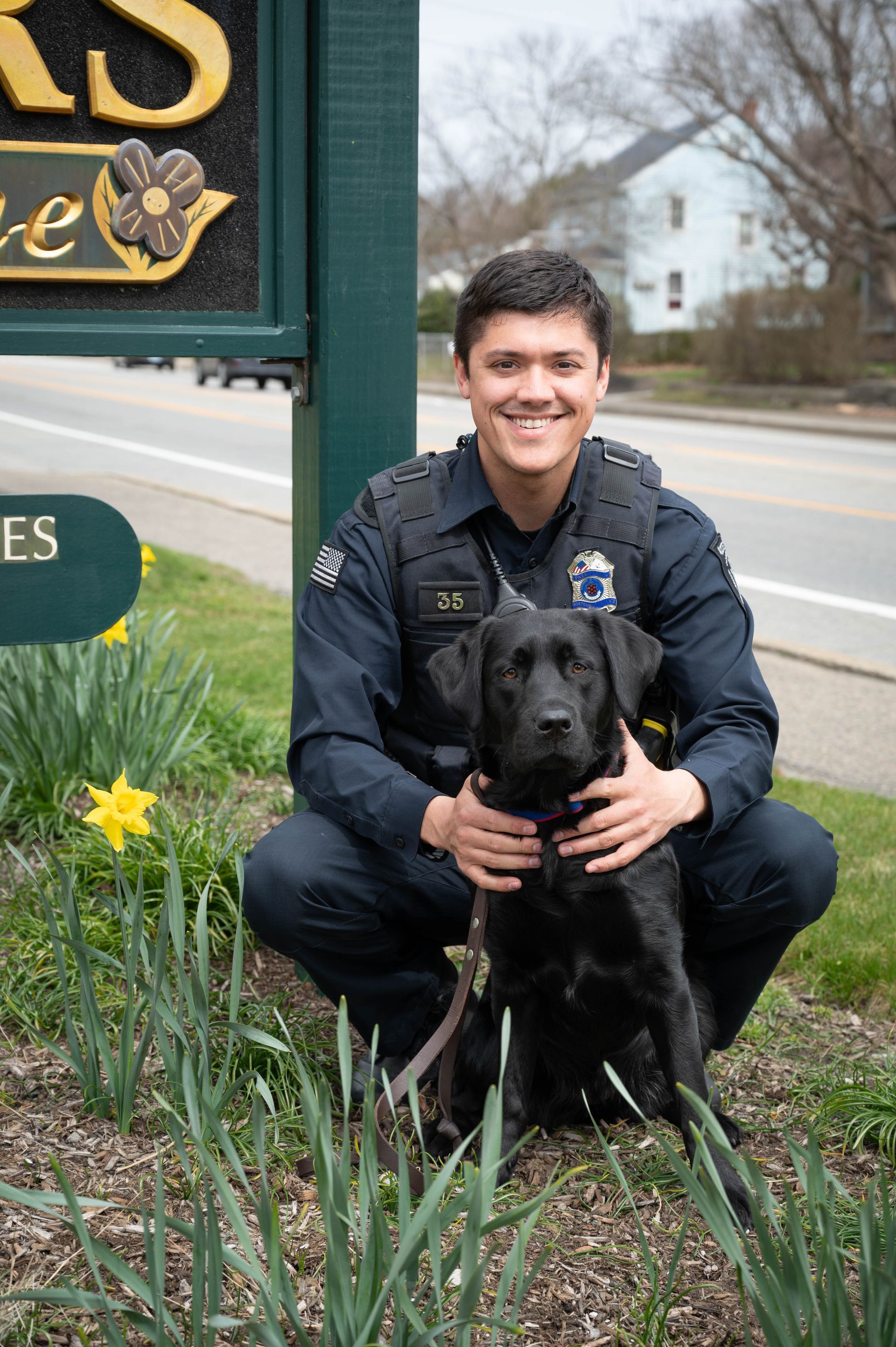 A picture of Holly, a black Labrador, and her handler Westley Lemar.
