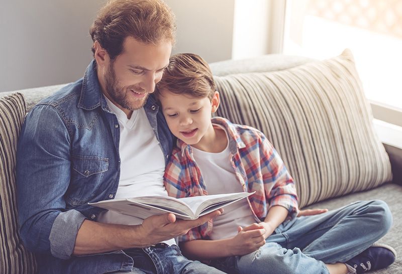 Father and son reading books