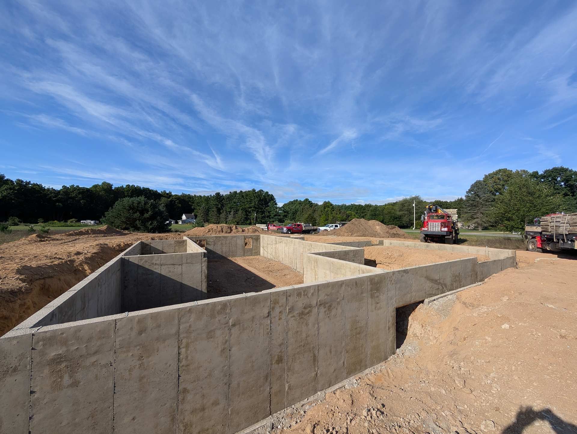 Concrete foundation walls for a new house under construction on a sunny, clear day.