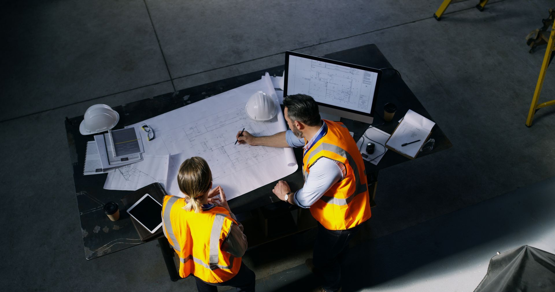 Two Engineers Going Over A Blueprint — Elizabethtown, KY — A A Portable Sanitation