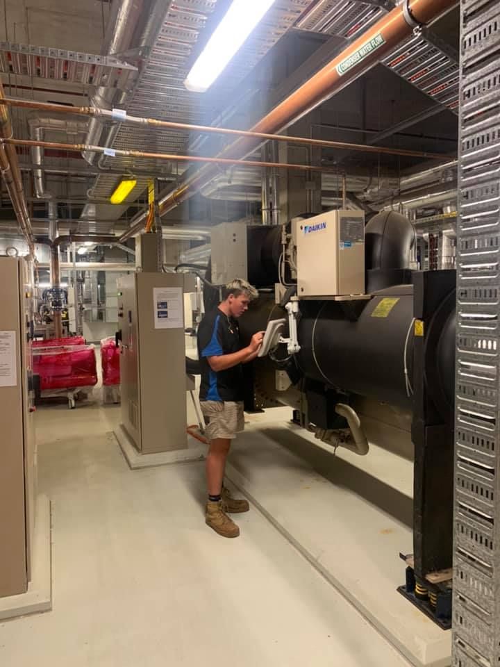 A Technician in A Mechanical Room Operates Equipment — Leader Air Conditioning in Queanbeyan, NSW