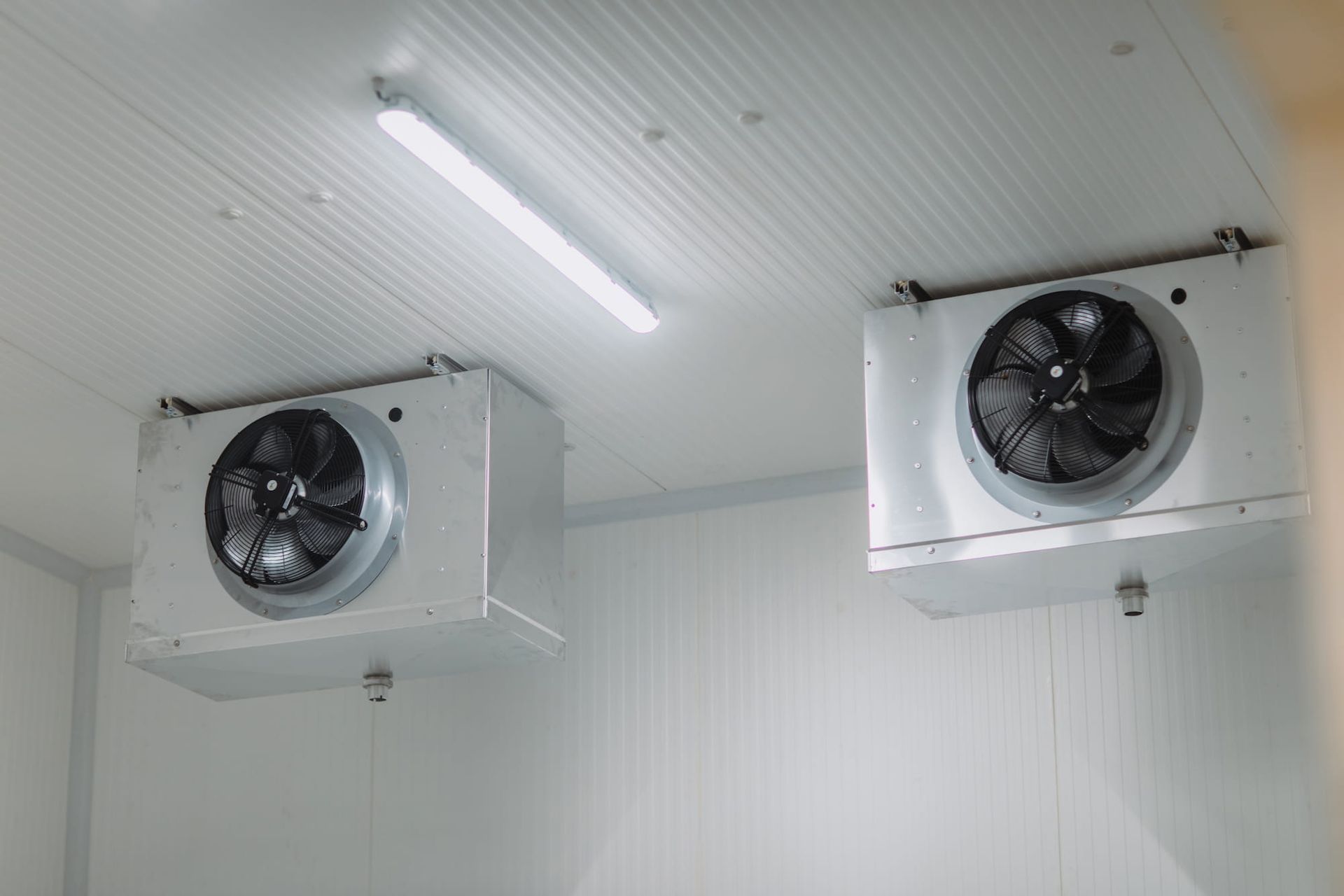 Two Industrial Cooling Units Mounted on A Ceiling — Leader Air Conditioning in Queanbeyan, NSW