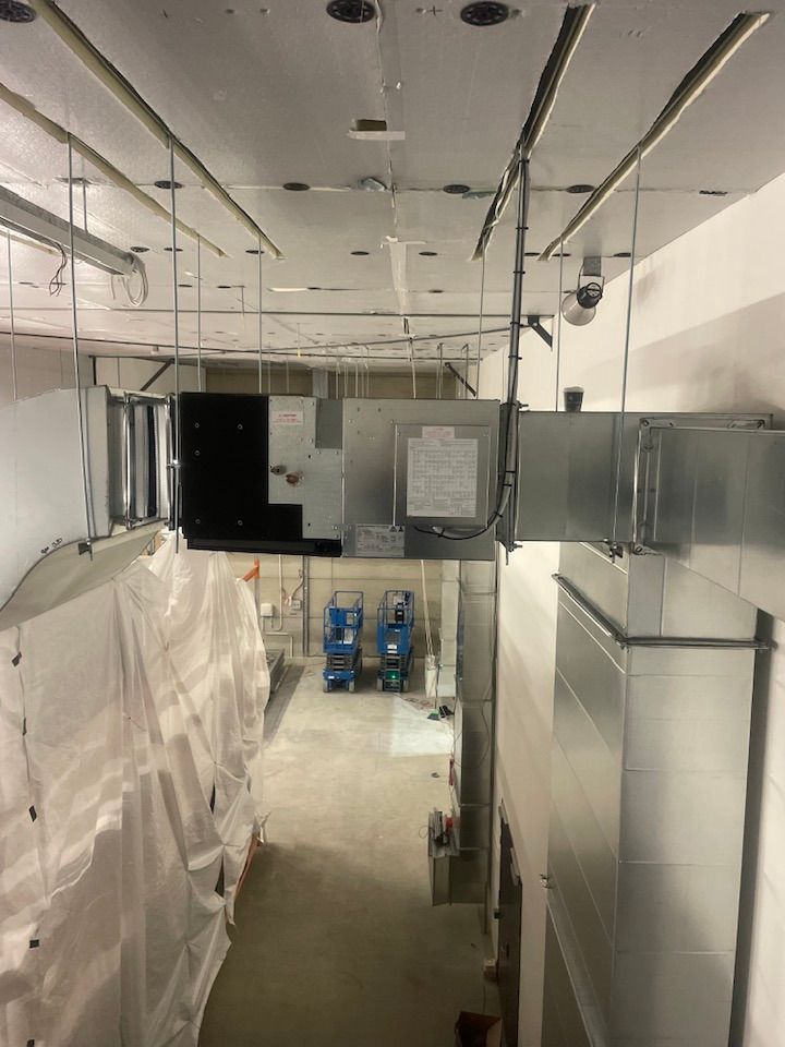 HVAC System in A Construction Zone. Silver Ductwork, White Walls, and Equipment — Leader Air Conditioning in Goulburn, NSW