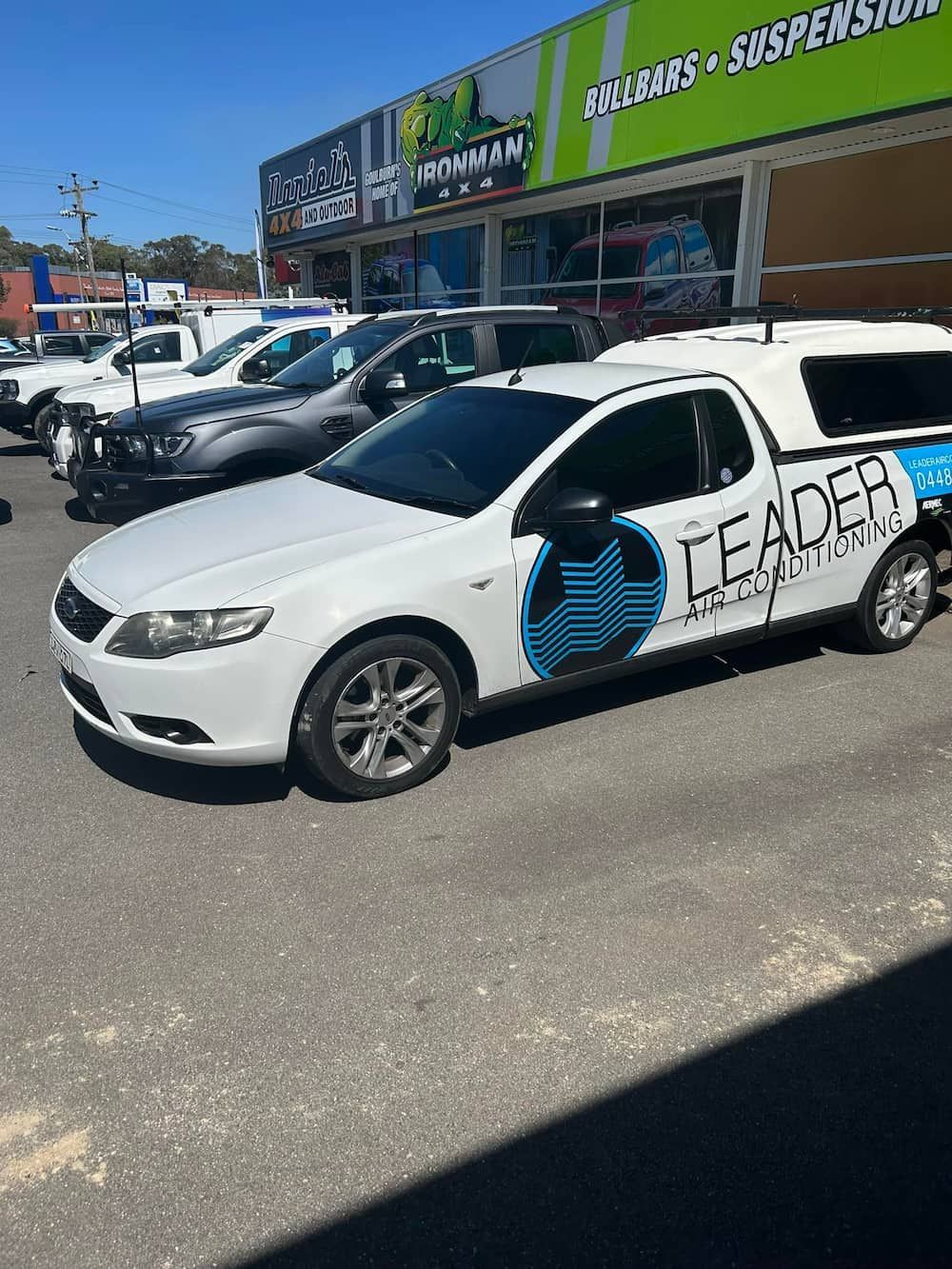 White Work Truck Parked Outside a Building — Leader Air Conditioning in Queanbeyan, NSW