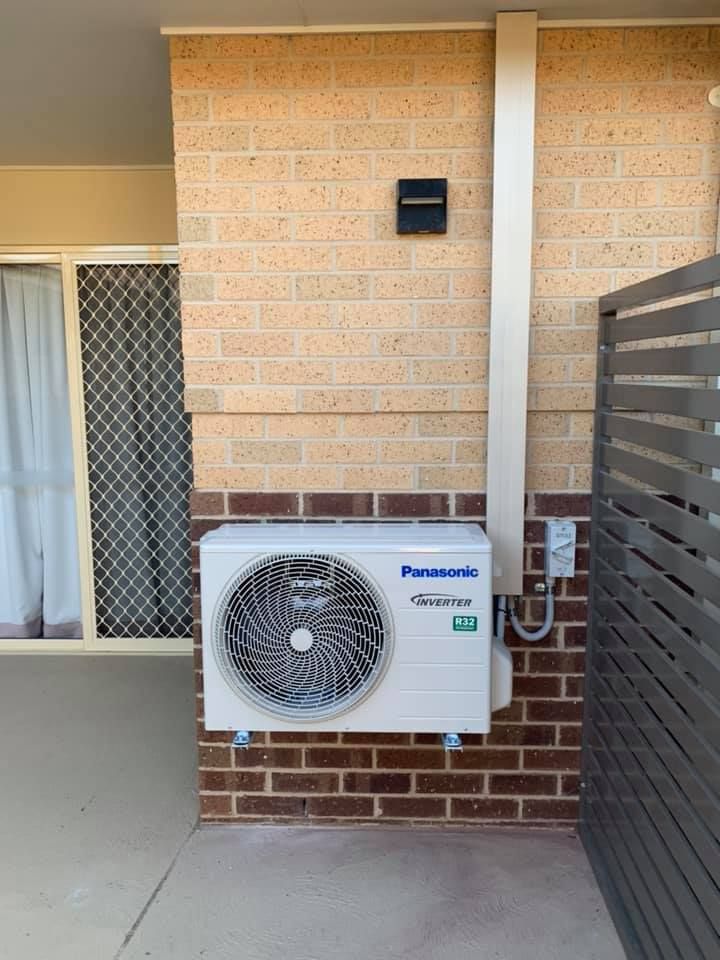 Panasonic Air Conditioner Mounted on A Brick Wall — Leader Air Conditioning in Queanbeyan, NSW