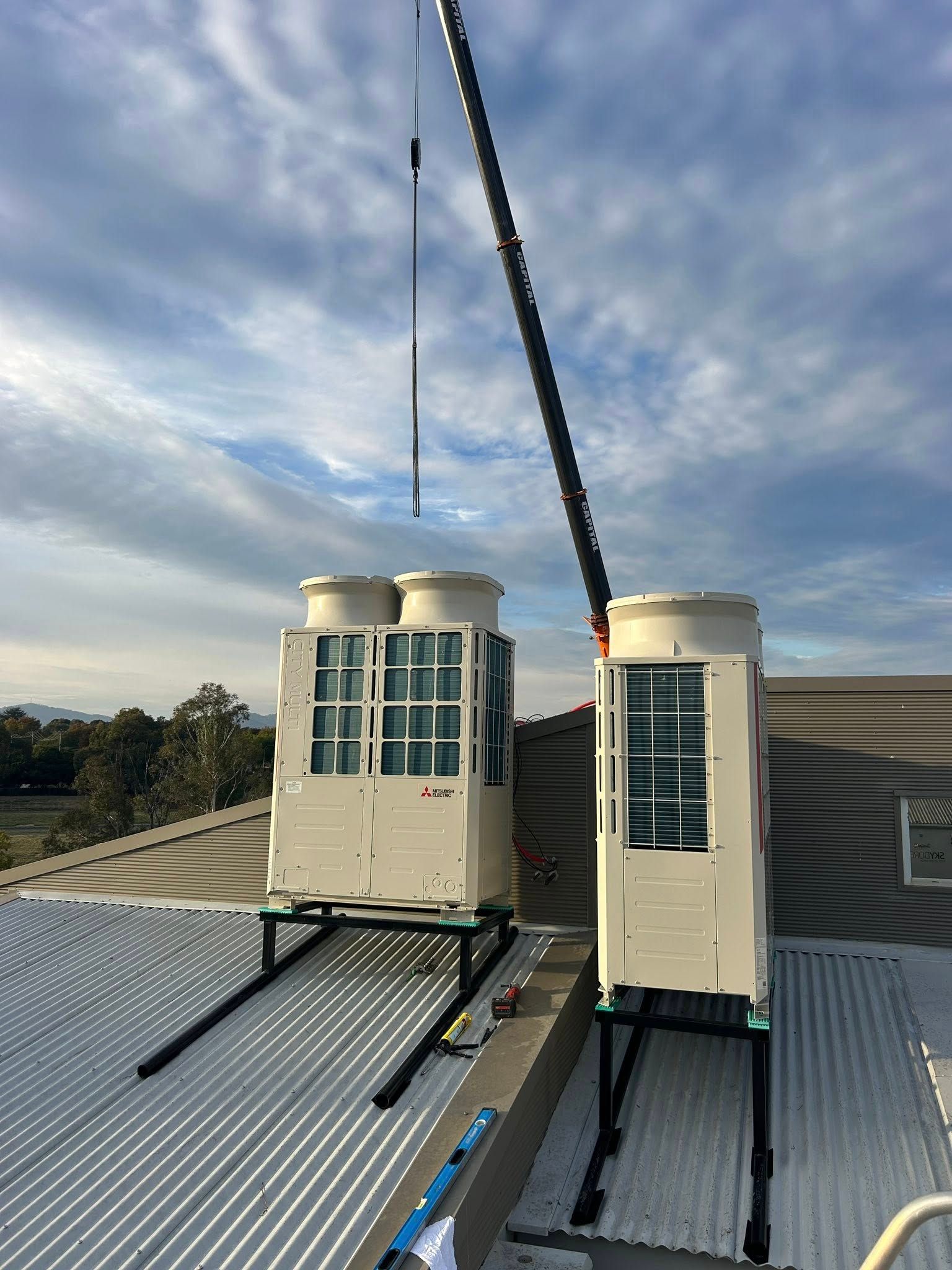 Two Rooftop Hvac Units Being Installed by A Crane — Leader Air Conditioning in Queanbeyan, NSW