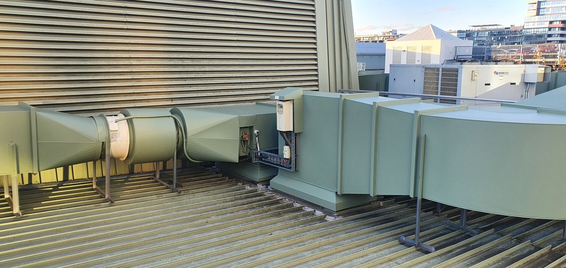 HVAC Ductwork on A Rooftop with A Corrugated Metal Surface — Leader Air Conditioning in Queanbeyan, NSW