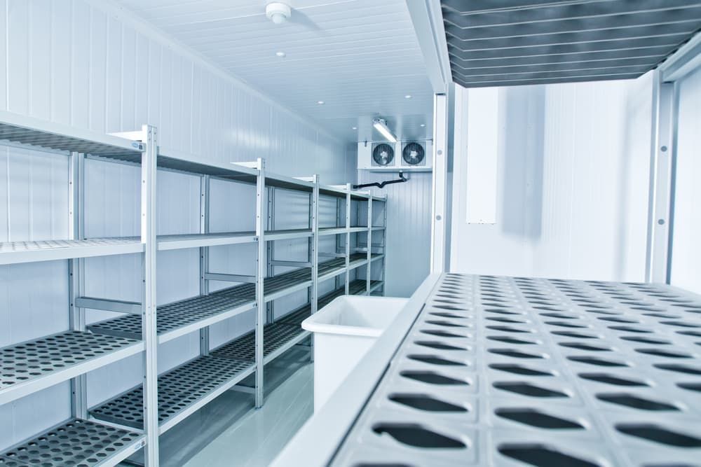 Empty White Walk-In Freezer with Metal Shelving — Leader Air Conditioning in Queanbeyan, NSW