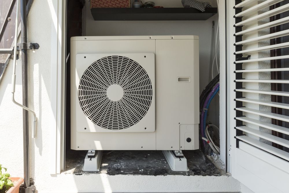 White Air Conditioning Unit, Outdoor Setting, Mounted on A Platform — Leader Air Conditioning in Young, NSW