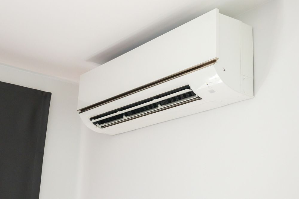 White Wall-Mounted Air Conditioner with Black Vents — Leader Air Conditioning in Queanbeyan, NSW