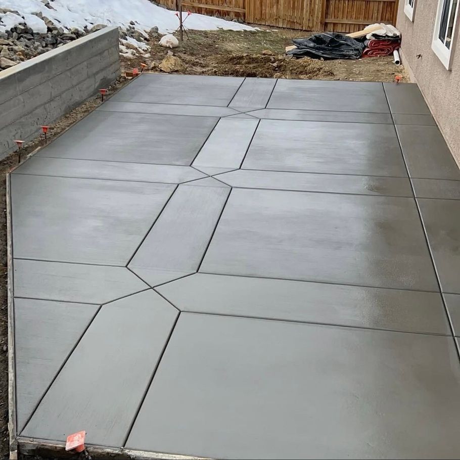 A concrete patio is being built in front of a house