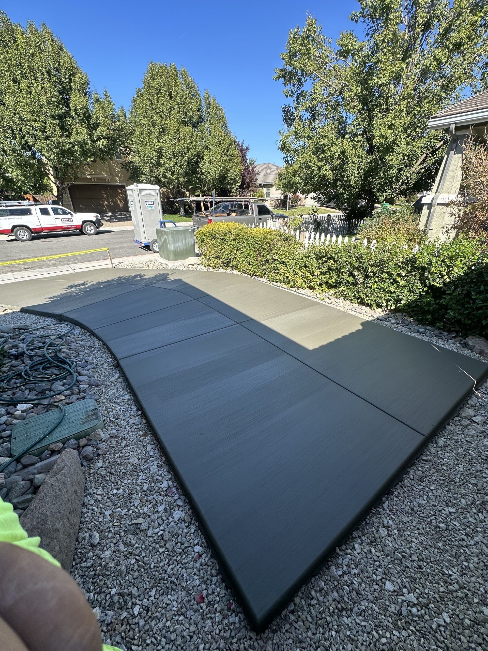 A large piece of concrete is sitting on top of a pile of gravel.