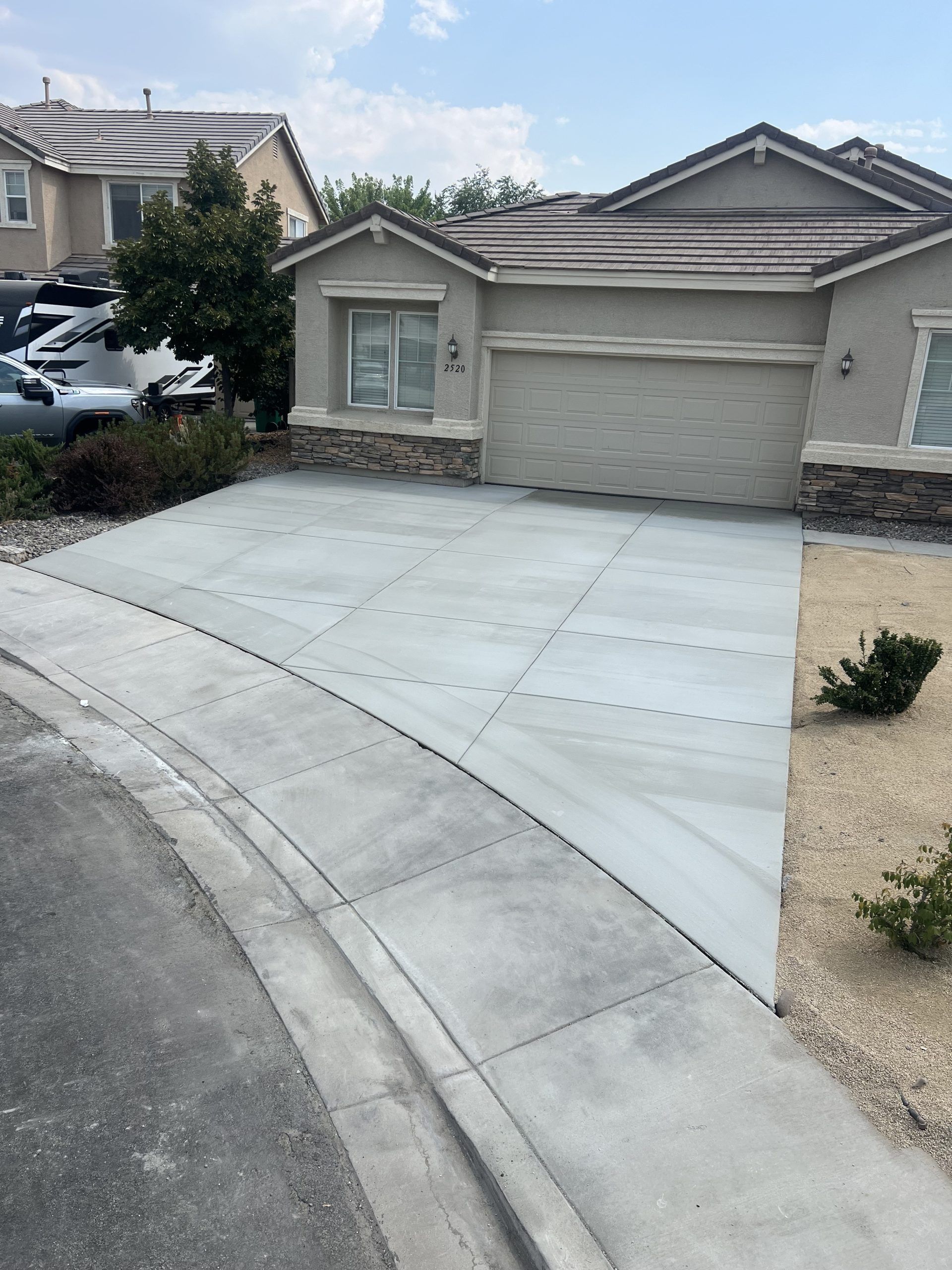 A house with a concrete driveway in front of it