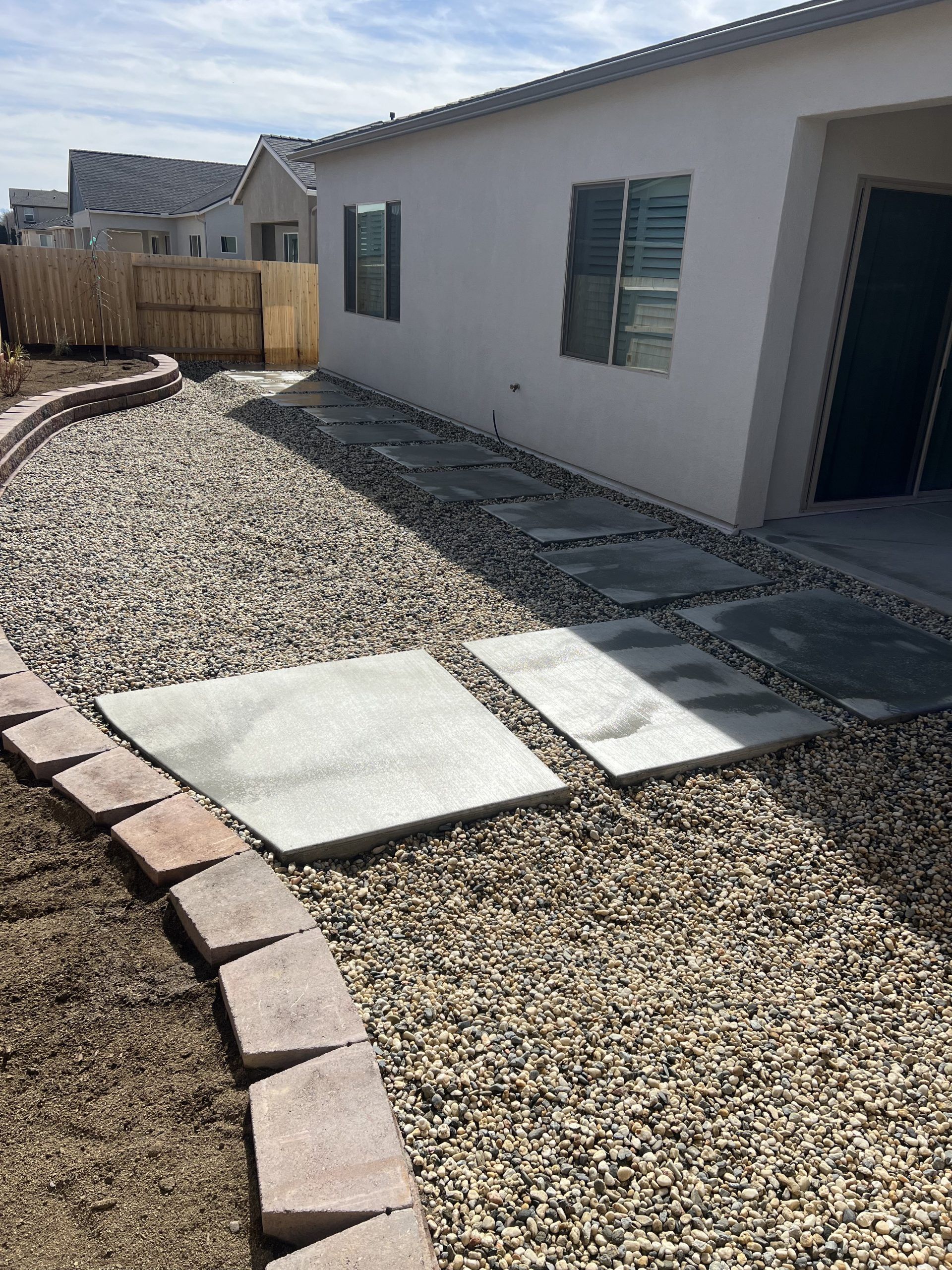 A white house with a gravel walkway in front of it