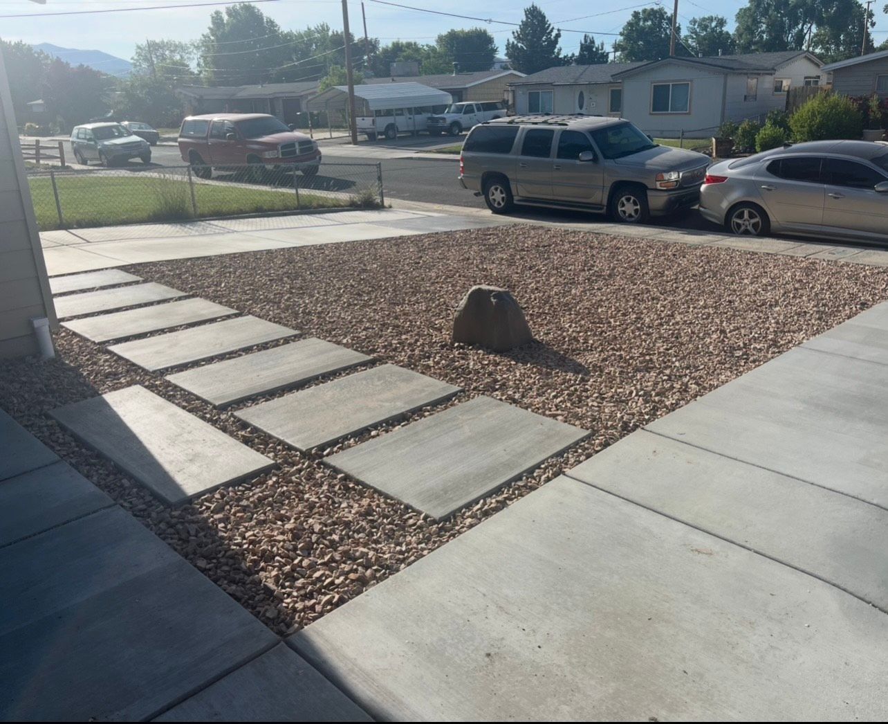 A silver suv is parked on the side of the road
