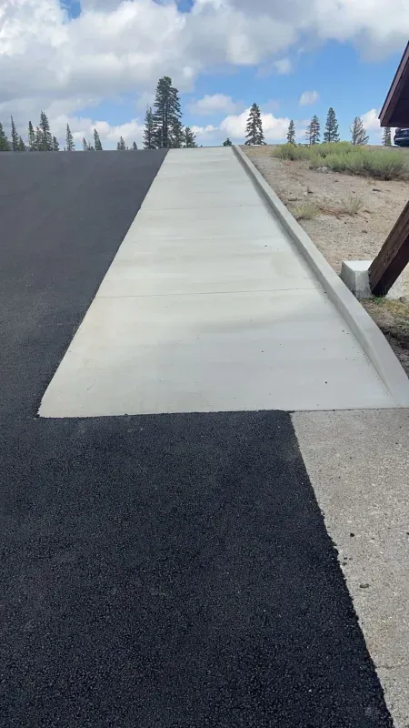 A concrete walkway is being built on the side of a road.