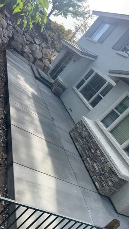 A house with a concrete walkway leading to it