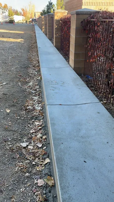 There is a concrete wall along the side of the road.