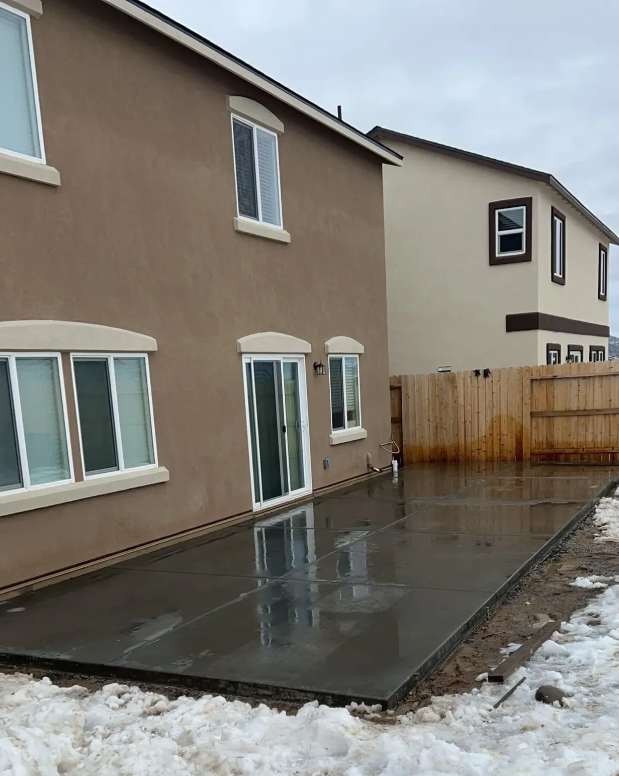 A house with a concrete patio in front of it.
