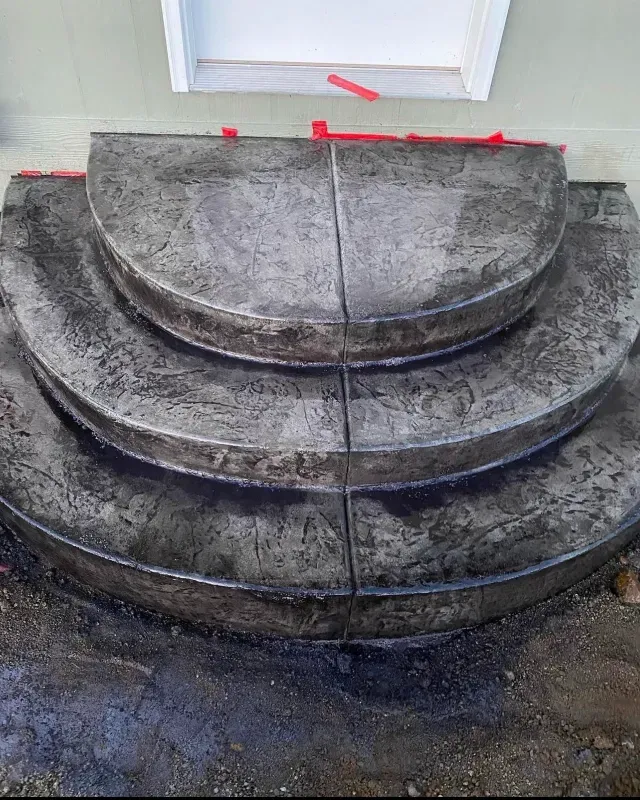 A concrete staircase is being built in front of a house.