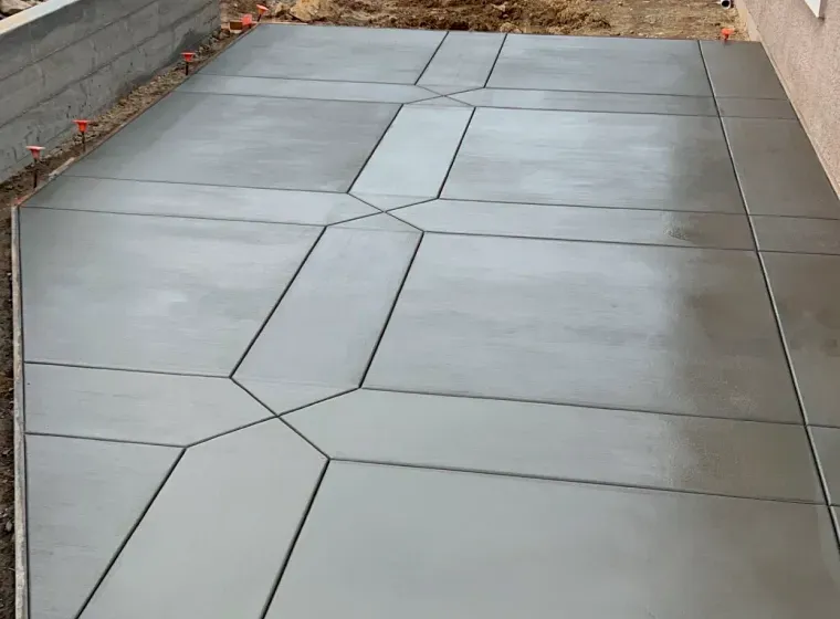 A concrete walkway with a geometric pattern on it