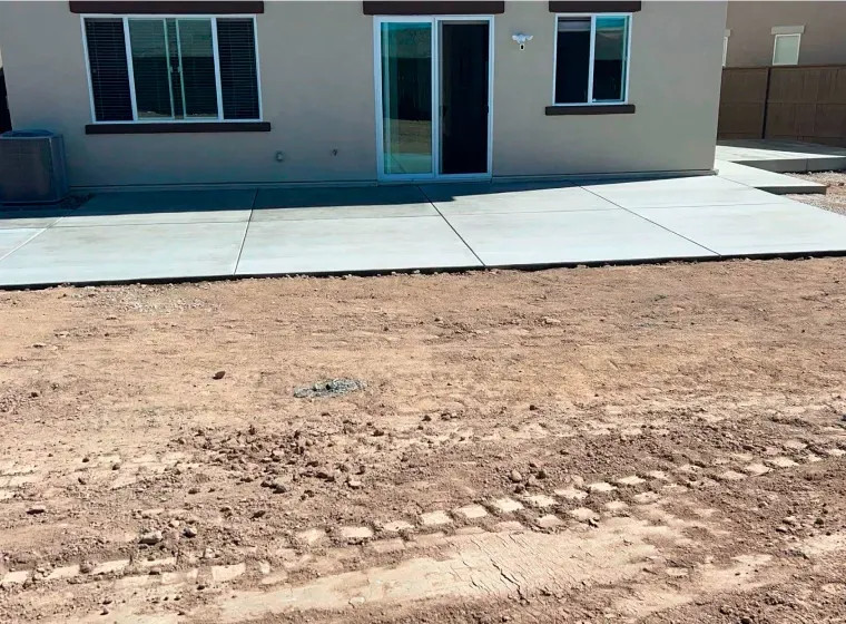 A house with a concrete walkway in front of it