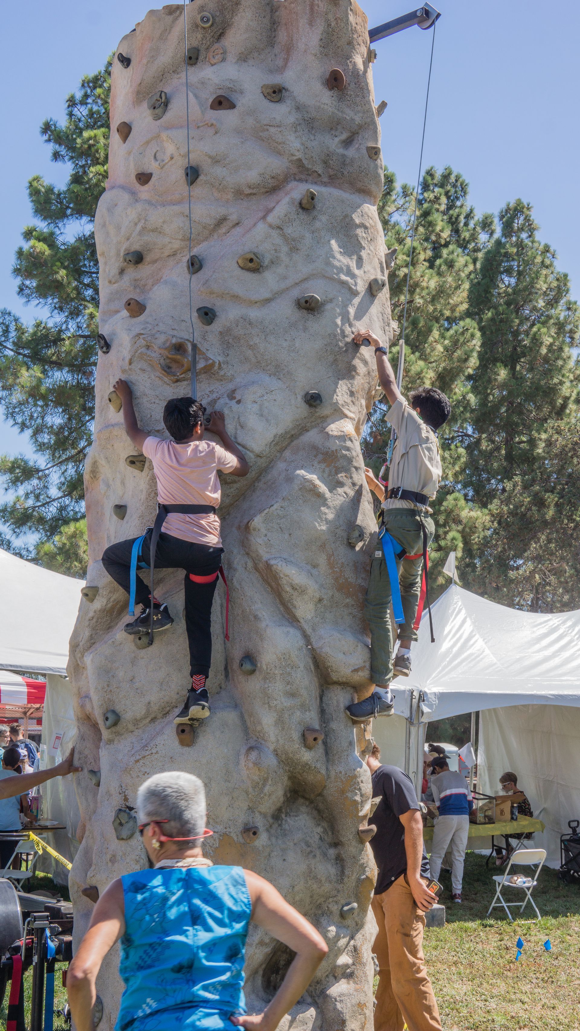 A group of people are climbing a rock wall