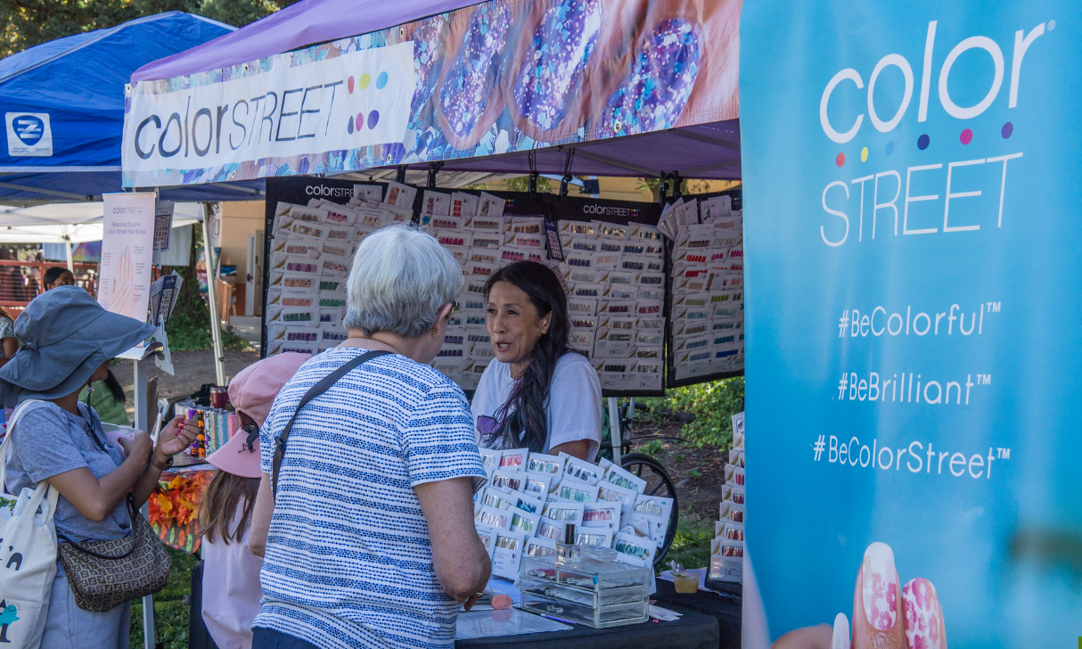 A man is standing in front of a picture frame with a lotus flower on it.