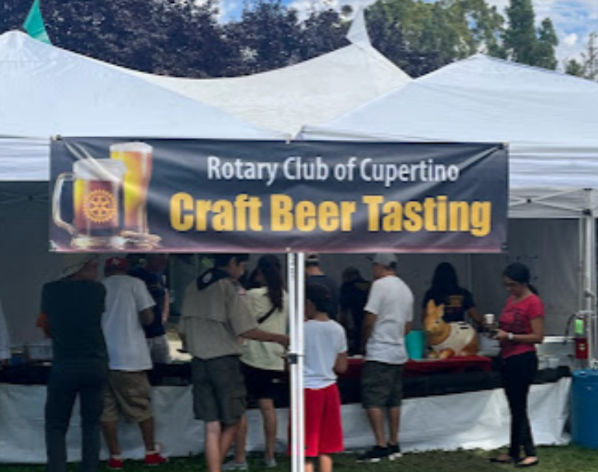 A sign for the rotary club of cupertino craft beer tasting