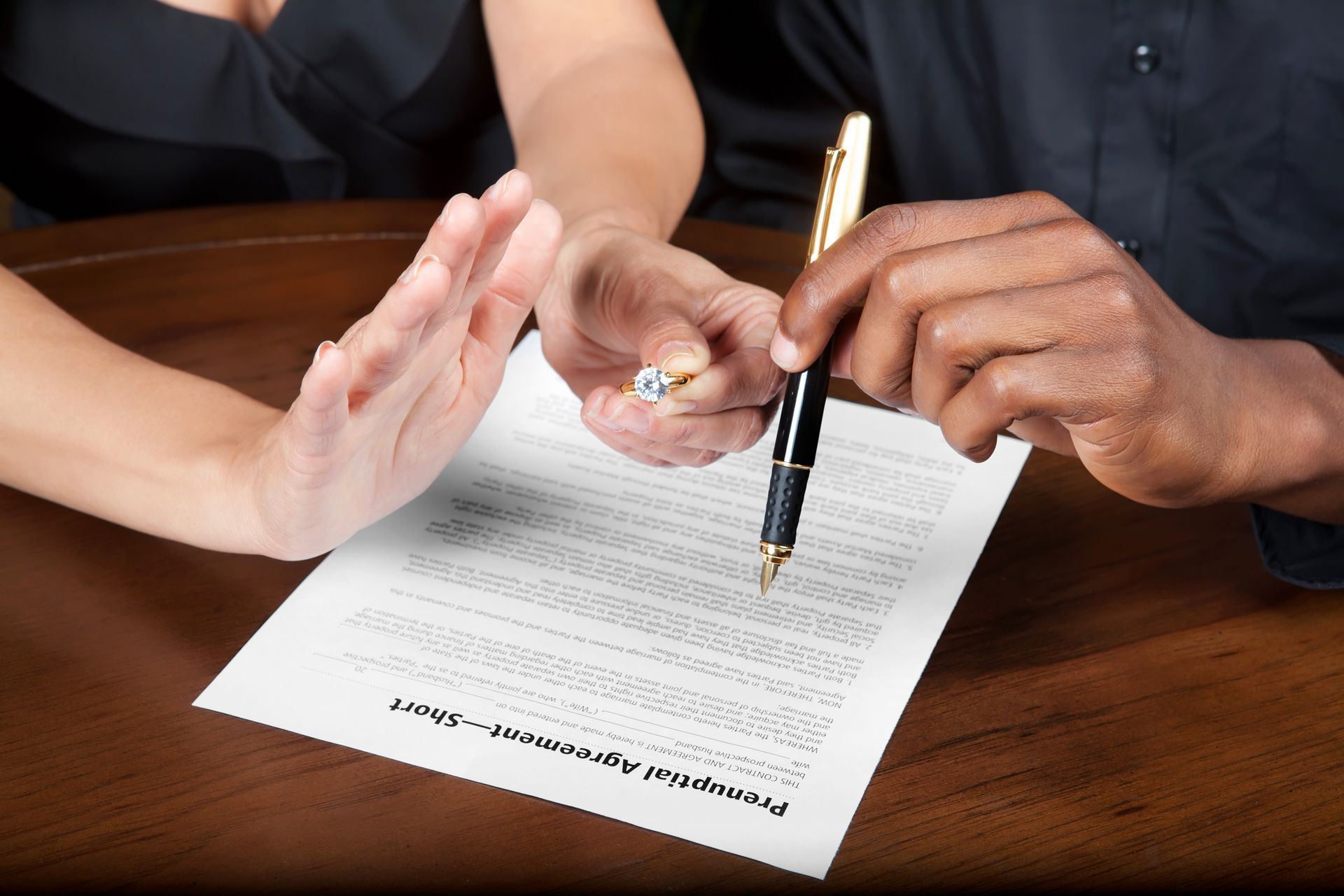 Divorce judgement modification document being signed by two individuals.