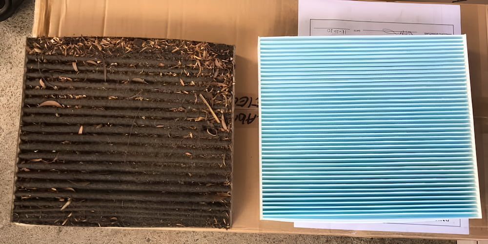 A Dirty Filter And A Clean Filter Are On A Cardboard Box — Mudgeeraba Auto Electrical & Mechanical In Mudgeeraba, QLD
