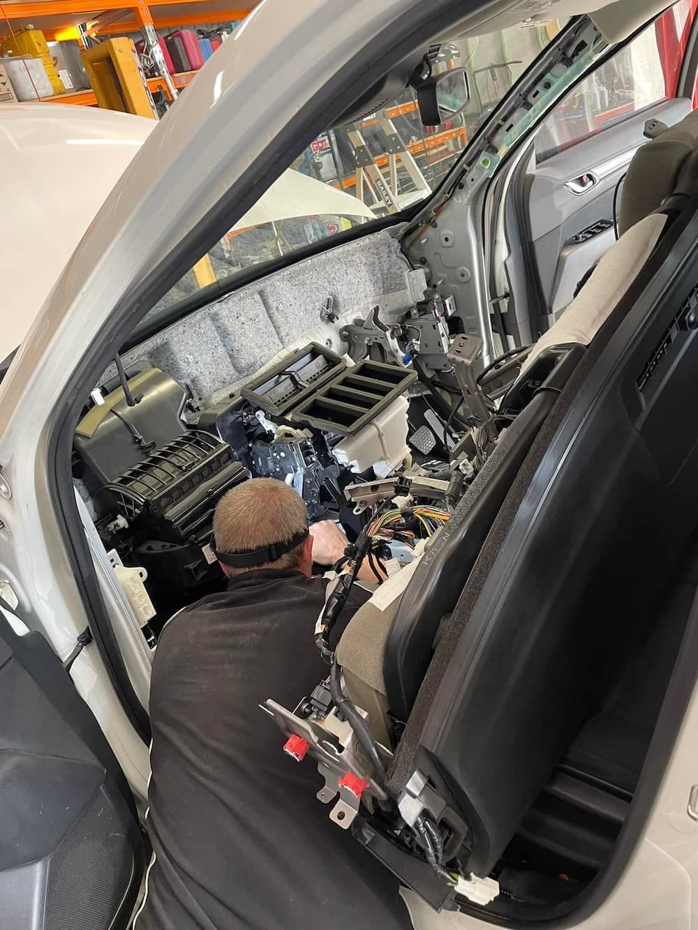 A Man Is Working On The Inside Of A Car — Mudgeeraba Auto Electrical & Mechanical In Mudgeeraba, QLD
