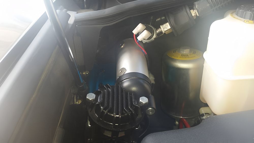 A Close Up Of A Air Compressor In The Engine Compartment Of A Car — Mudgeeraba Auto Electrical & Mechanical In Mudgeeraba, QLD