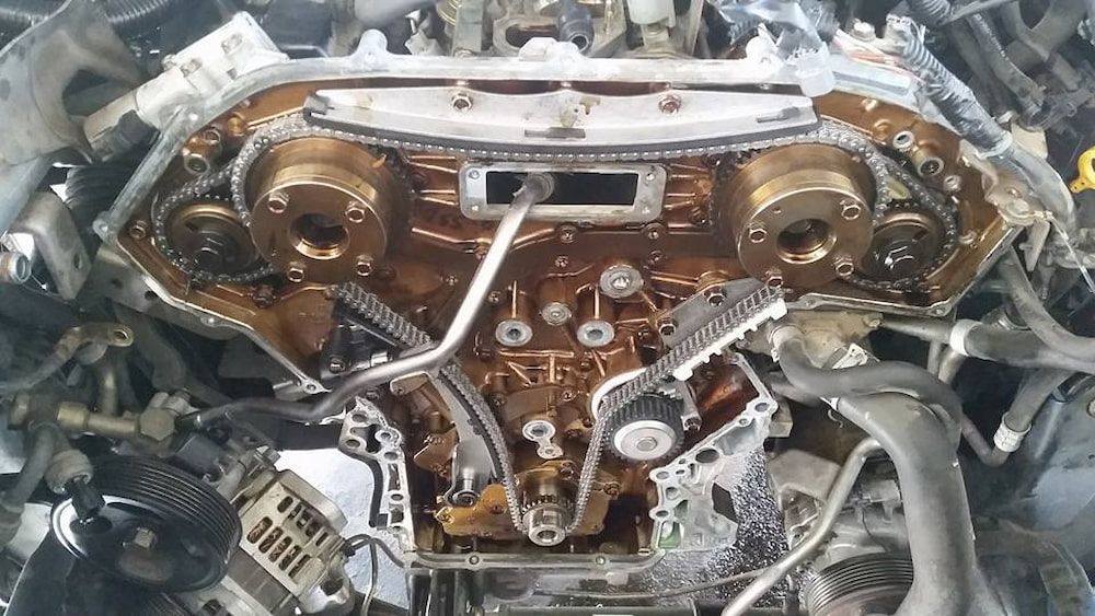 A Close Up Of A Car Engine With A Lot Of Chains On It — Mudgeeraba Auto Electrical & Mechanical In Mudgeeraba, QLD