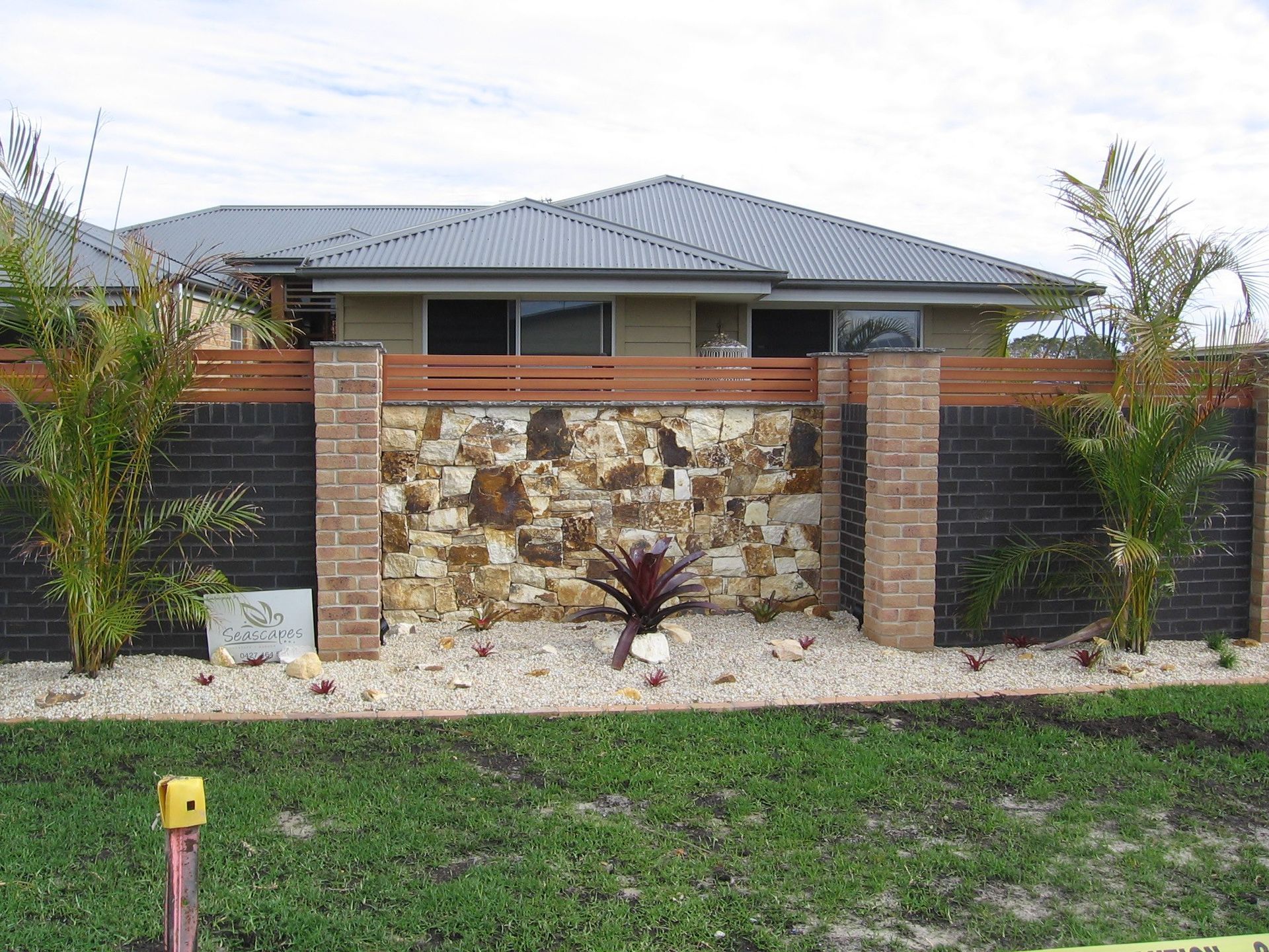 Another House With a Stone Wall and a Brick Fence in Front of It — Seascapes Landscape Construction in Kendall, NSW