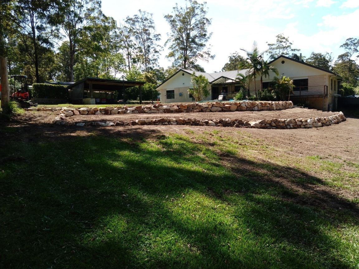 A House With a Lot of Grass in Front of It — Seascapes Landscape Construction in Kendall, NSW