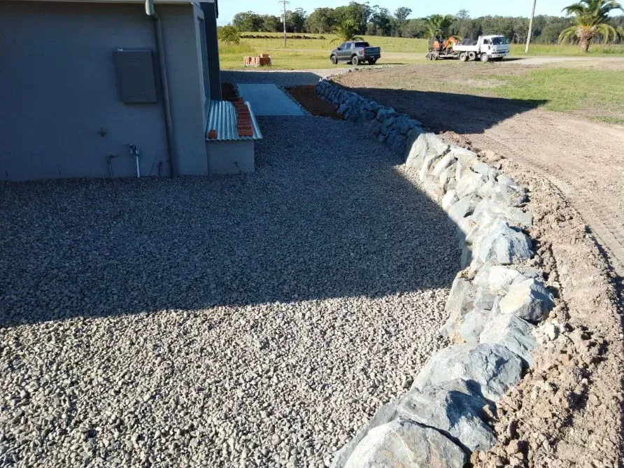A Gravel Driveway With a House in the Background — Seascapes Landscape Construction in Kendall, NSW