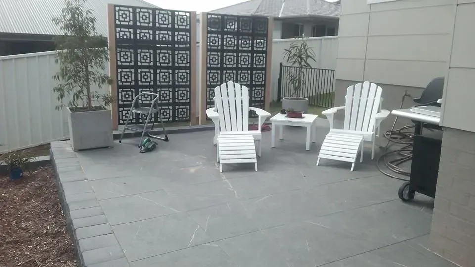 A Patio With Chairs, Tables and a Grill — Seascapes Landscape Construction in Kendall, NSW