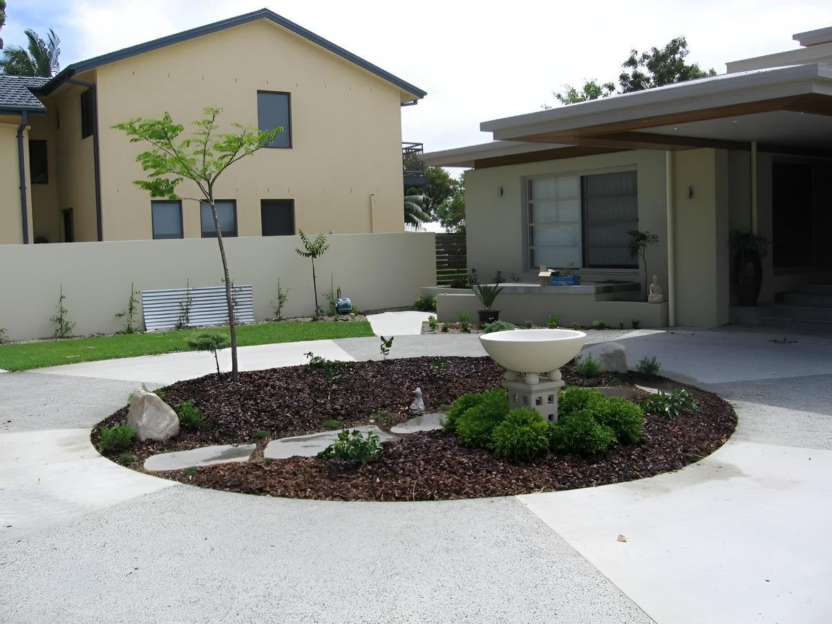 A House With a Circular Garden in Front of It — Seascapes Landscape Construction in Lake Cathie, NSW